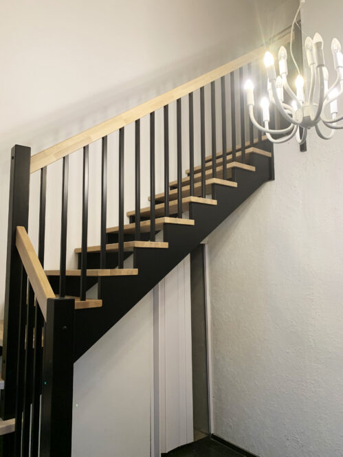 U-shaped staircase with oak steps.