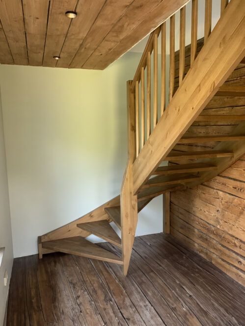 U-shaped wooden staircase made of oak.